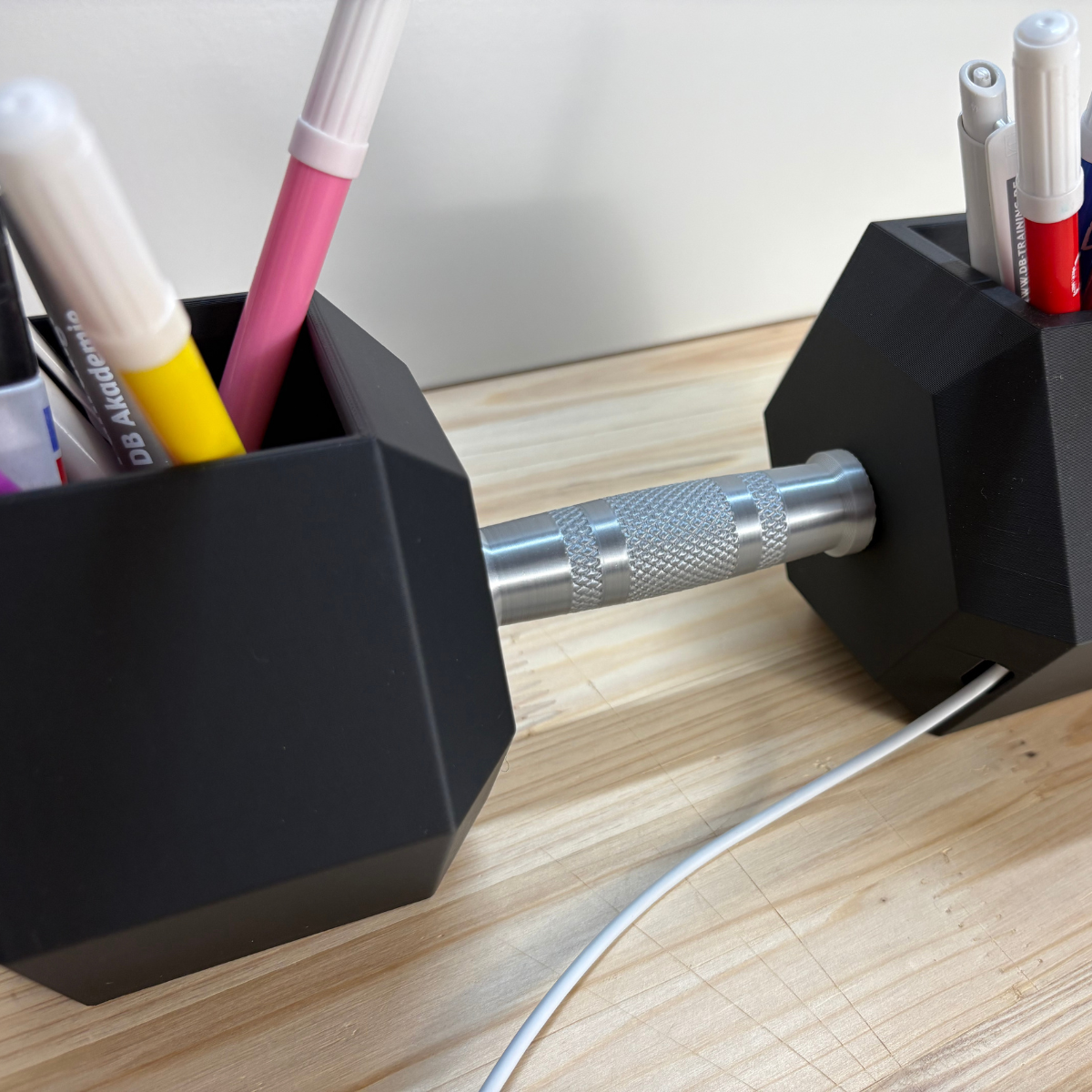 Das Kabel wird bei der MagSafe Ladestation in Hanteloptik im inneren nach hinten geführt.